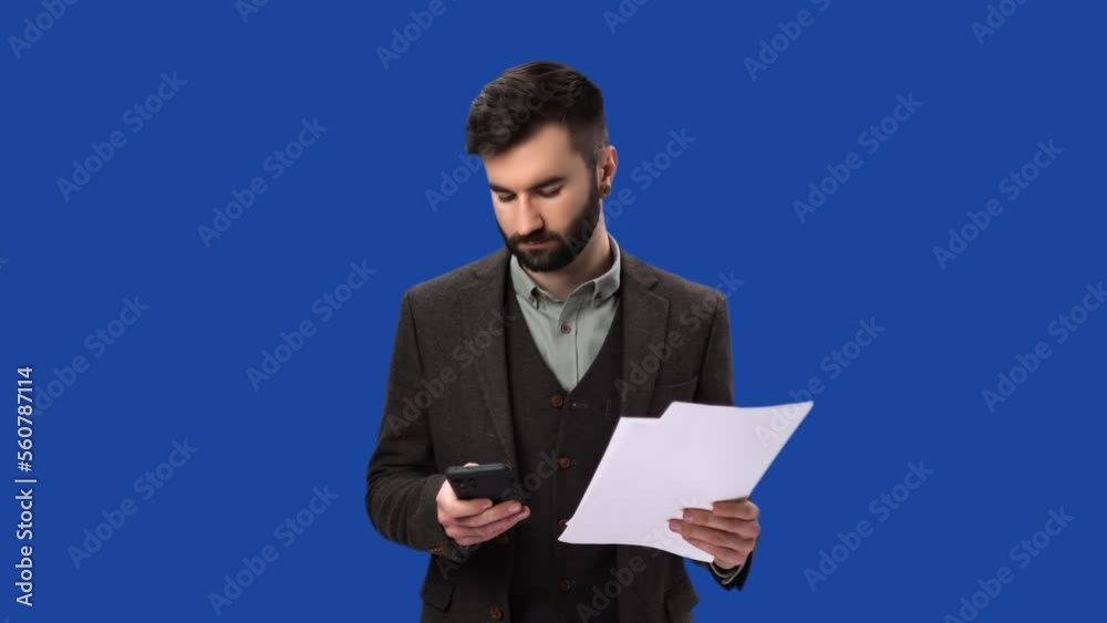 Smart business man working with paper document use smartphone isolated on blue screen background Smart business man working with paper document use smartphone isolated on blue screen background