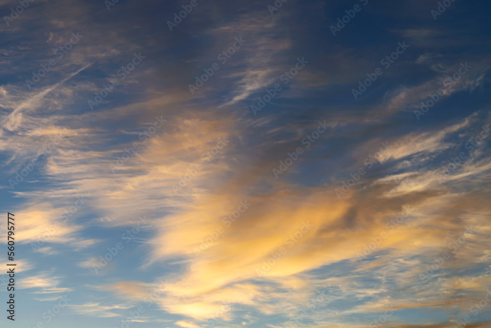 blue sky with golden clouds beautifully illuminated by the sun as a ...