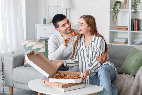 Happy young couple eating t...