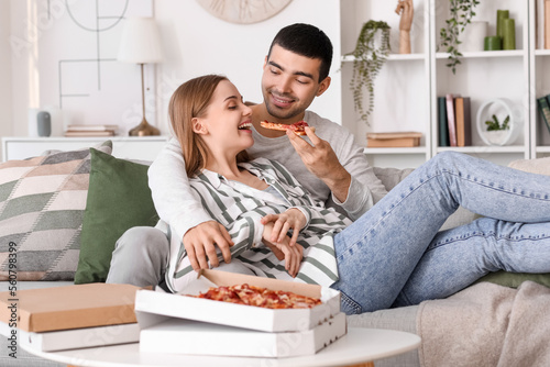 Happy young couple eating t...