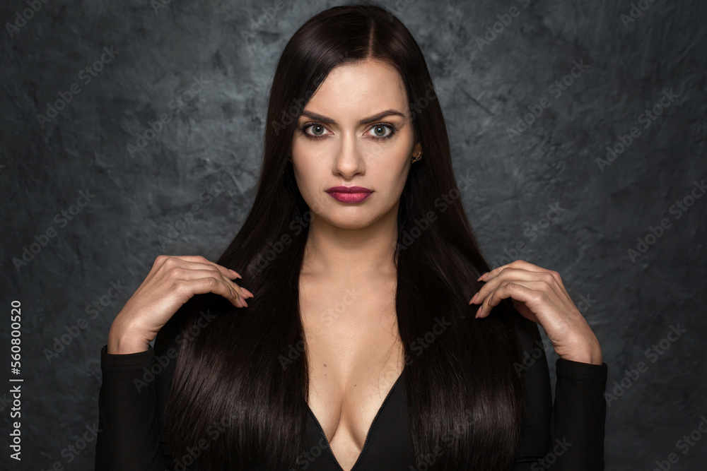 Luxurious woman with black chic hair with a deep neckline