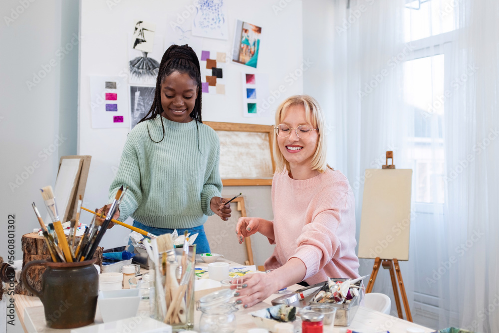 Young female artists is in their painting studio Young female artists is in their painting studio