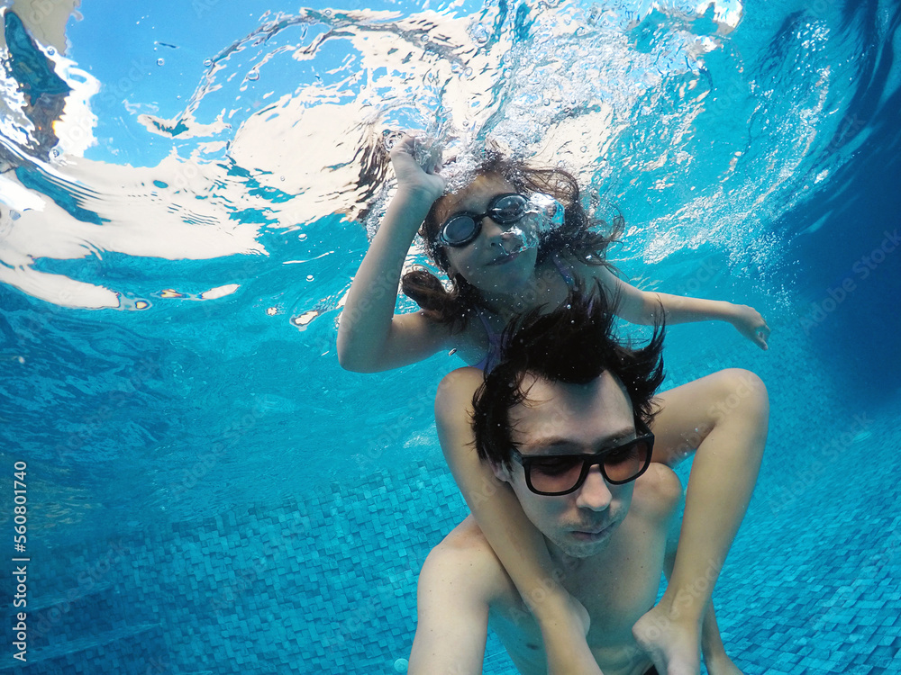 pai e filha se divertindo na piscina mergulho 
