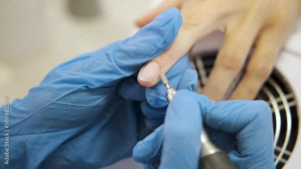 hardware manicure. removal of varnish with a milling cutter. close-up. processing nails with a milling cutter. nail care. hardware manicure. removal of varnish with a milling cutter. close-up. processing nails with a milling cutter. nail care.