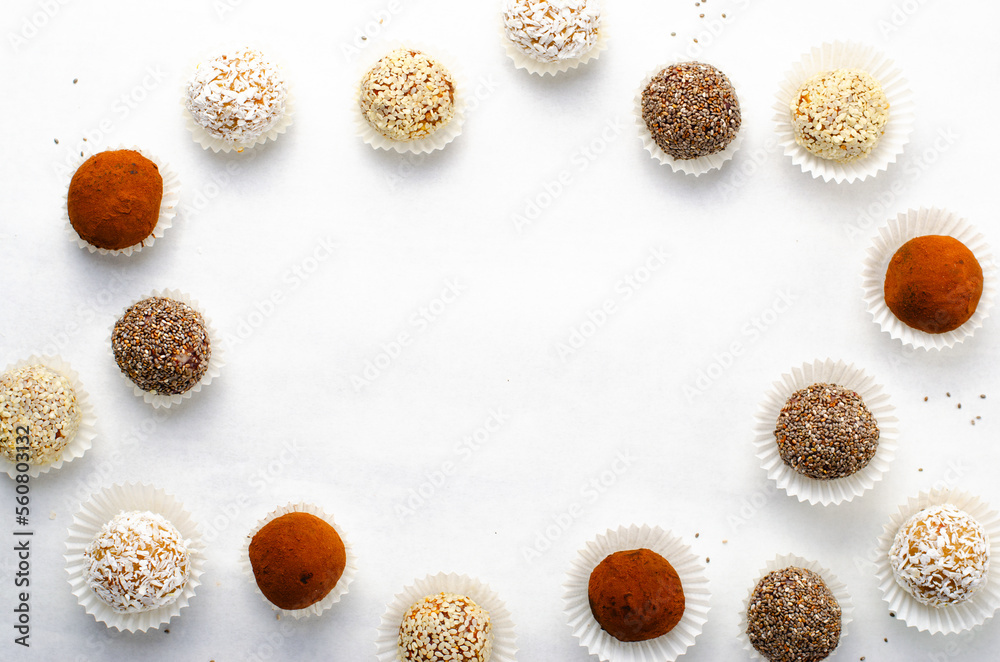 Assorted Vegan Sweets, Delicious Candy Balls with seeds, nuts and cocoa powder, Healthy Candies on Bright Background Assorted Vegan Sweets, Delicious Candy Balls with seeds, nuts and cocoa powder, Healthy Candies on Bright Background