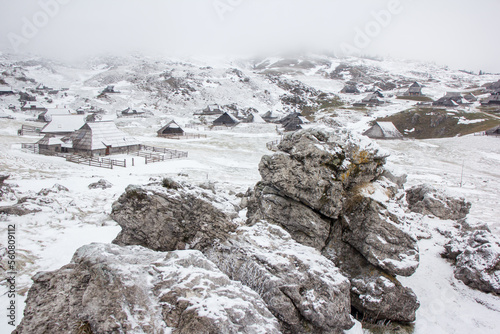 Velika planina mountain 1666 m in Kamnik Savinja Alps in Slovenia, winter hiking in herdsmen’s huts village covered with snow photo