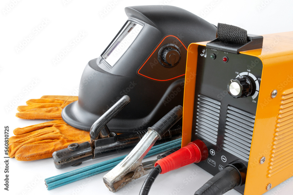 Inverter welding machine and mask, Electro welding equipment on a white background Inverter welding machine and mask, Electro welding equipment on a white background