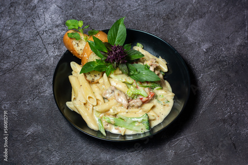 Alfredo with Chicken Creamy Pasta with garlic bread served in dish isolated on grey background top view of indian and bangladesh food photo