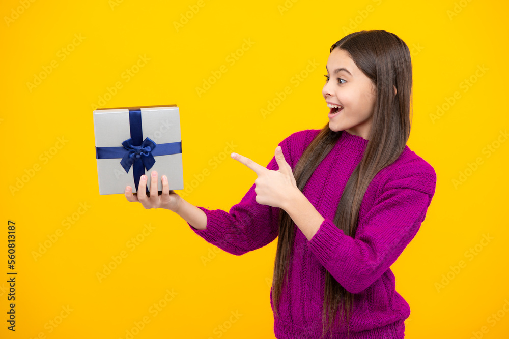Teenager child with gift box. Present for winter holidays. Happy New Year or Christmas. Kid in sweater hold present box with gift ribbon bow. Teenager child with gift box. Present for winter holidays. Happy New Year or Christmas. Kid in sweater hold present box with gift ribbon bow.