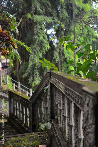 old stone staircase in bali island with tropical plants