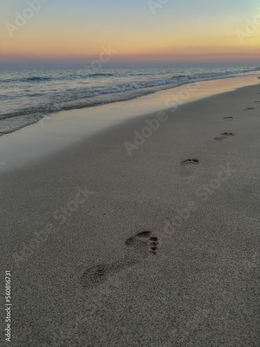 Footprints on the ocean. Loneliness. Beautiful sunset. soft focus