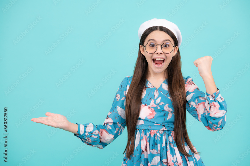Impressed teenage girl showing recommendation copyspace. Child teenager points away, pointing aside at copy space. Excited teenager, amazed and cheerful emotions. Impressed teenage girl showing recommendation copyspace. Child teenager points away, pointing aside at copy space. Excited teenager, amazed and cheerful emotions.