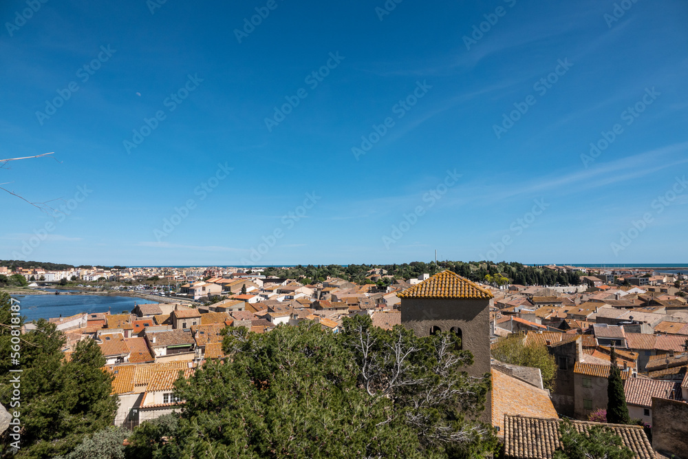 View of the European city with red tiled roofs, port and sea. France. Mediterranean.