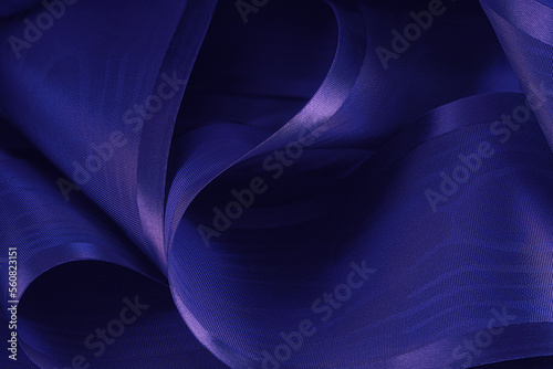 Abstract background. Swirling roll of  satin fabric.Selective focus.