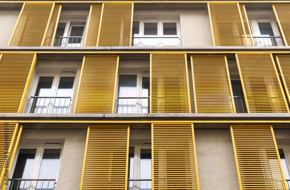 Windows of a building with yellow shutters in the old center of Budapest Windows of a building with yellow shutters in the old center of Budapest