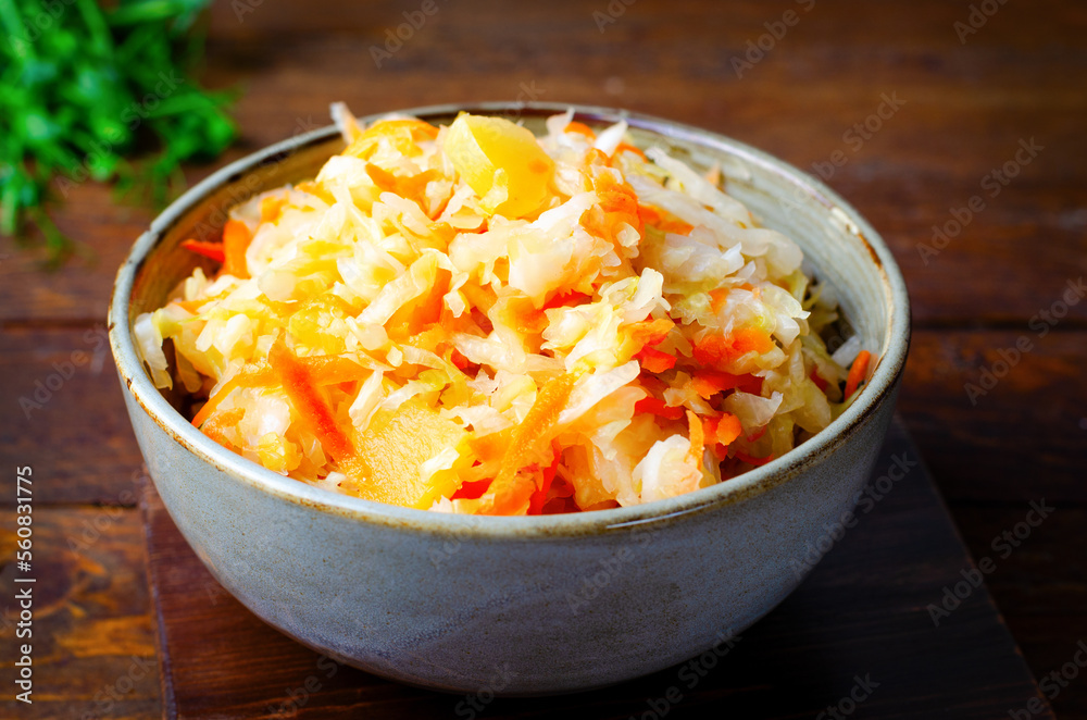 Sauerkraut, Shredded cabbage, apples, and carrots on dark rustic background, Fermented Food, Healthy Eating Sauerkraut, Shredded cabbage, apples, and carrots on dark rustic background, Fermented Food, Healthy Eating