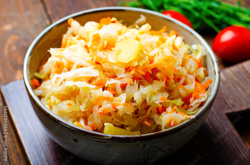 Sauerkraut, Shredded cabbage, apples, and carrots on dark rustic background, Fermented Food, Healthy Eating