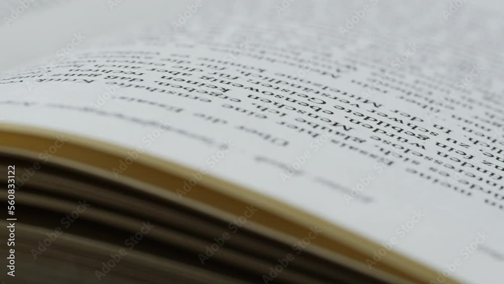 Woman Flipping german language book pages, reading and education, Flicking Through Old textbook Close-up, macro shot of paper in university library. Woman Flipping german language book pages, reading and education, Flicking Through Old textbook Close-up, macro shot of paper in university library.