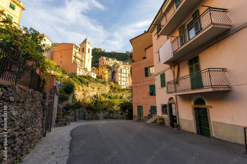 Street in touristic town, Manarola, Italy. Cinque Terre National Park. Sunny Sunset