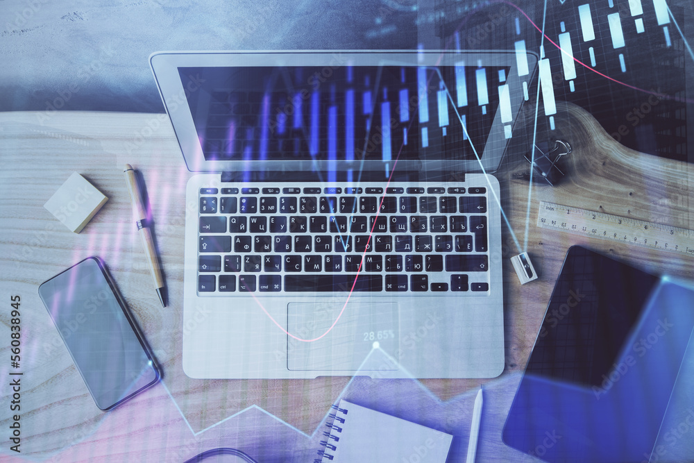 Financial graph colorful drawing and table with computer on background. Double exposure. Concept of international markets. Financial graph colorful drawing and table with computer on background. Double exposure. Concept of international markets.