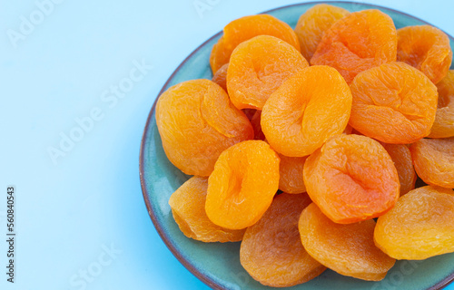 Dried apricots on blue background.