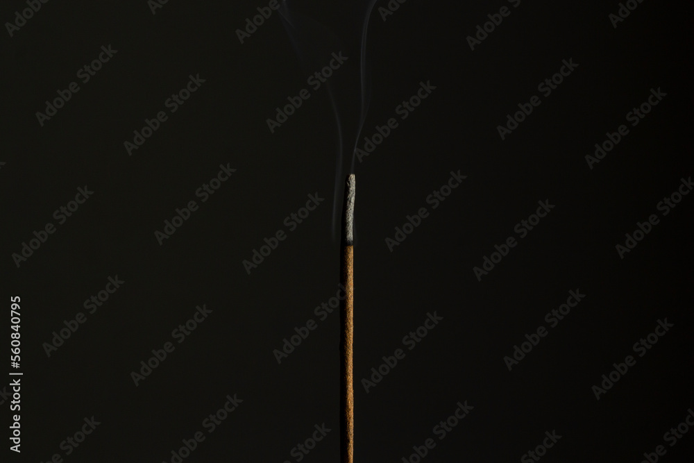 Flame in incense stick burning in the dark Flame in incense stick burning in the dark