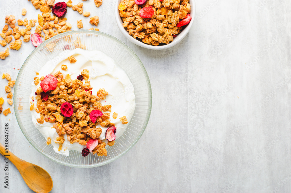 Granola with Yogurt in a Boal, Healthy Breakfast, Muesli with Dried Berries on Bright Concrete Background Granola with Yogurt in a Boal, Healthy Breakfast, Muesli with Dried Berries on Bright Concrete Background