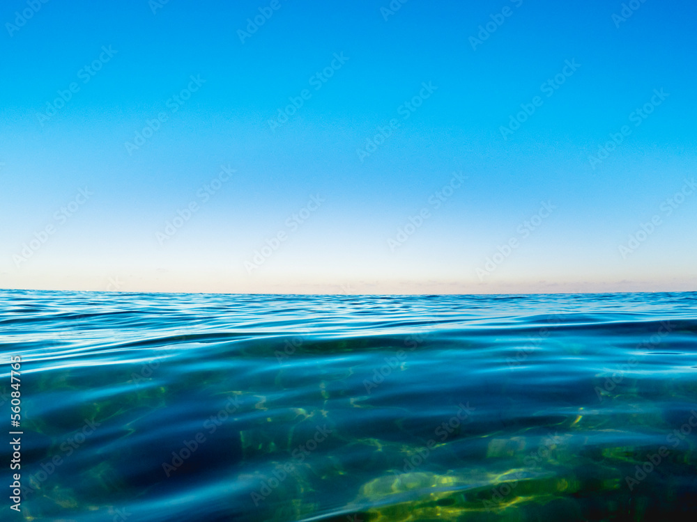 ocean surface with sky and reflections 