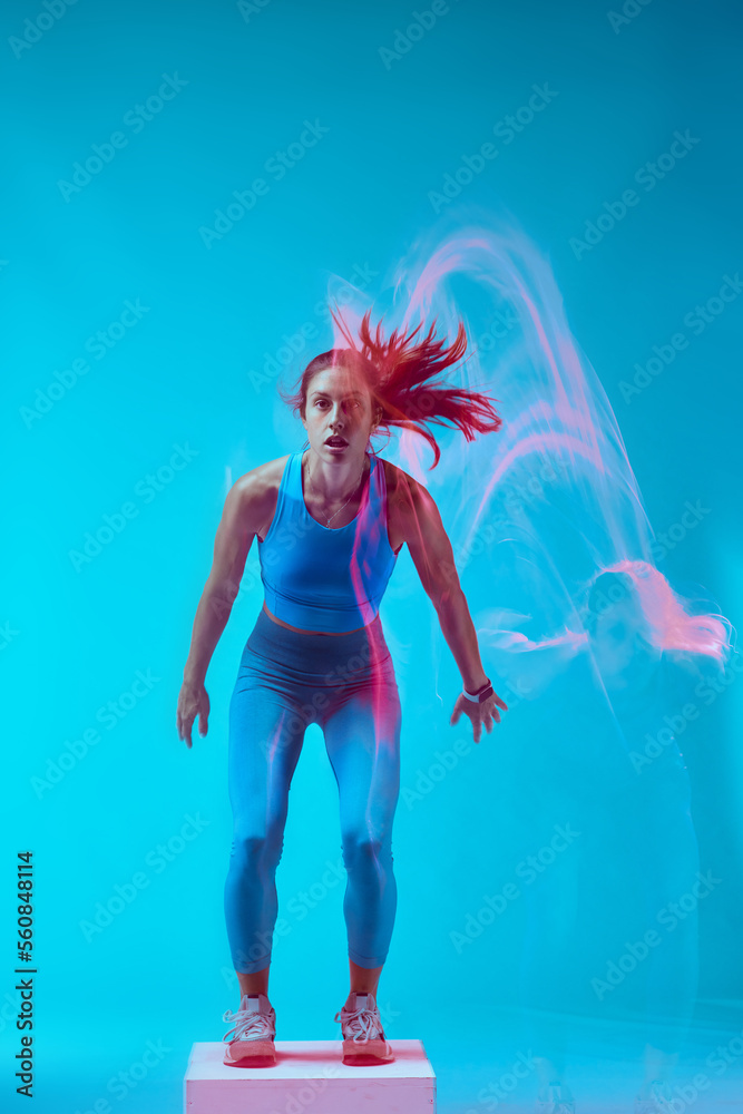 A sportswoman doing box jumps and exercising. Long exposure capture movement. A sportswoman doing box jumps and exercising. Long exposure capture movement.