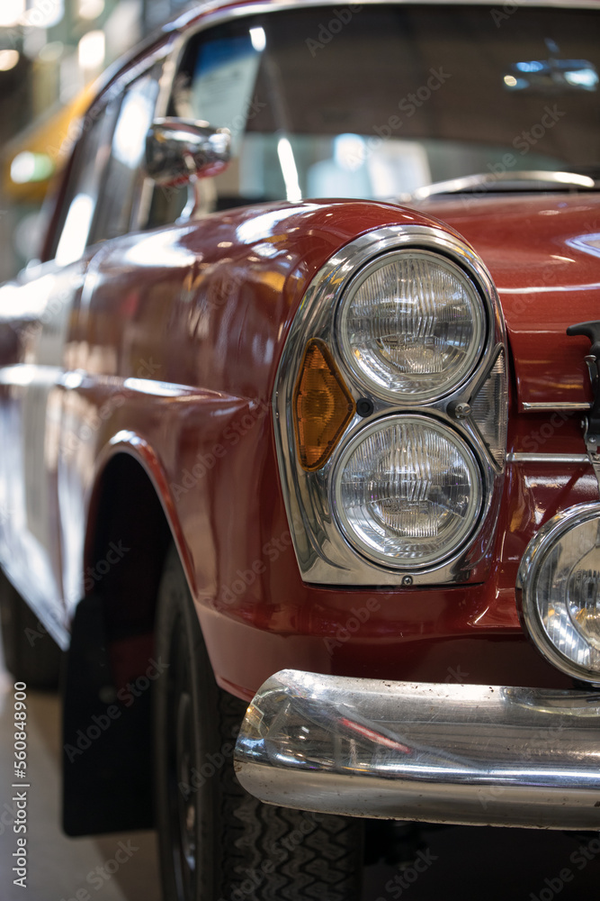 Headlight and hood of the old red car.