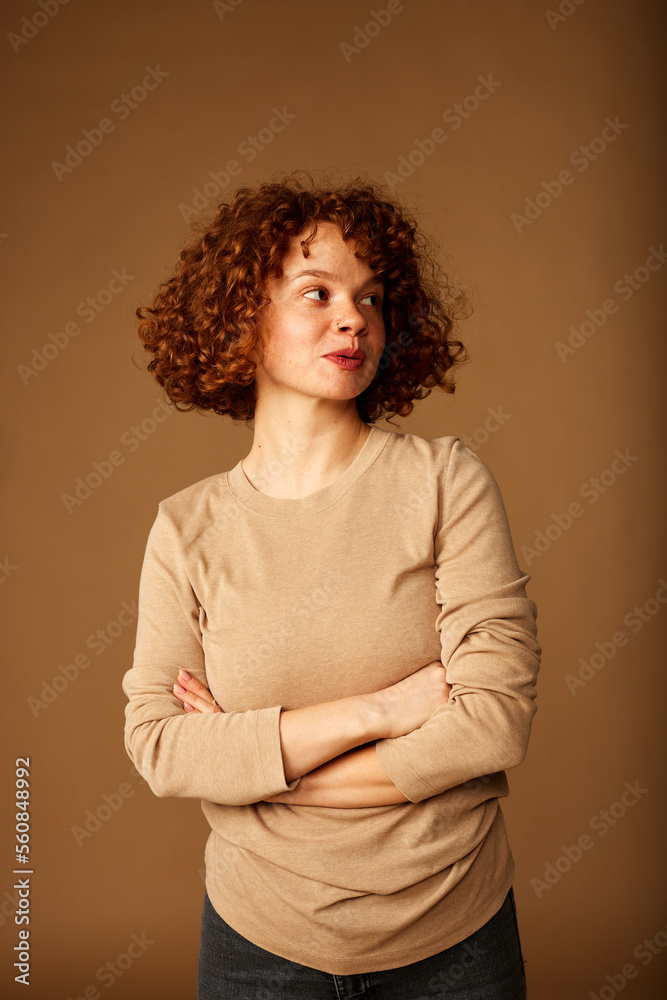 Portrait of a cute ginger girl with curly hair.