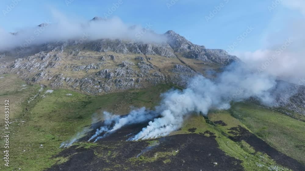 Controlled burning to generate pasture for cattle. Town of Rocías. Hills of the Ason Natural Park. Soba Valley, Cantabria, Spain, Europe Controlled burning to generate pasture for cattle. Town of Rocías. Hills of the Ason Natural Park. Soba Valley, Cantabria, Spain, Europe