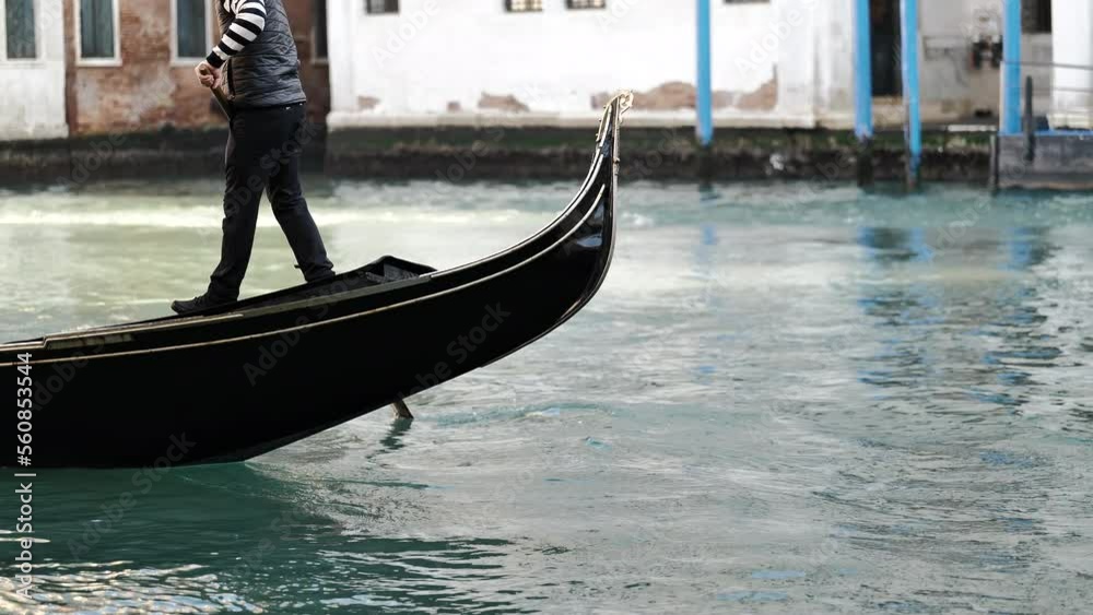 Venice, Italy - gondolas and gondoliers in the Grand Canal near the Rialto Bridge, in the San Marco Basin and between the canals of the lagoon city Venice, Italy - gondolas and gondoliers in the Grand Canal near the Rialto Bridge, in the San Marco Basin and between the canals of the lagoon city