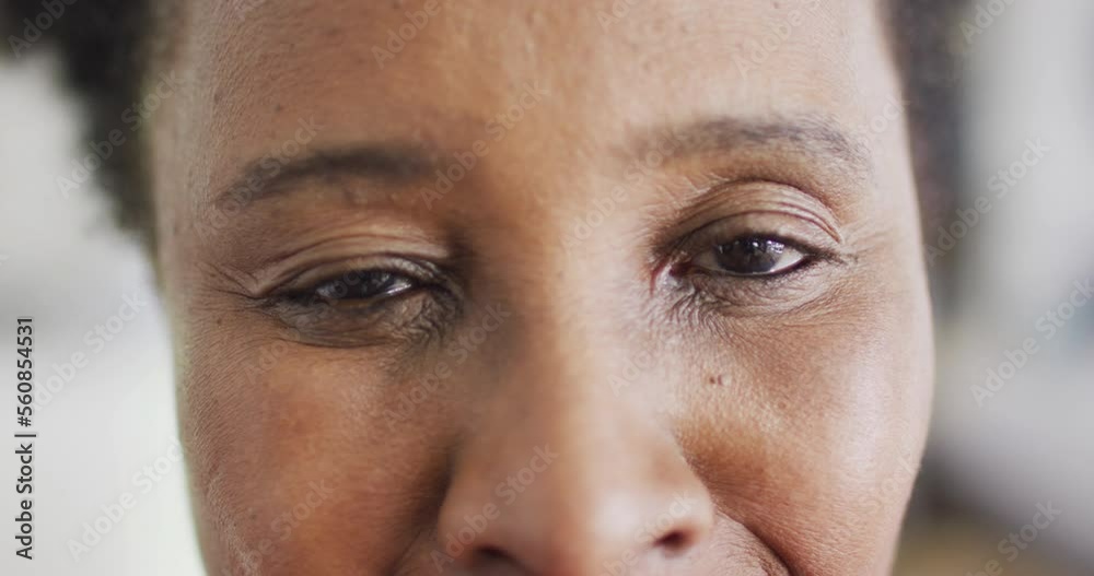 Video close up portrait of opening eyes of happy african american woman smiling at home, copy space Video close up portrait of opening eyes of happy african american woman smiling at home, copy space
