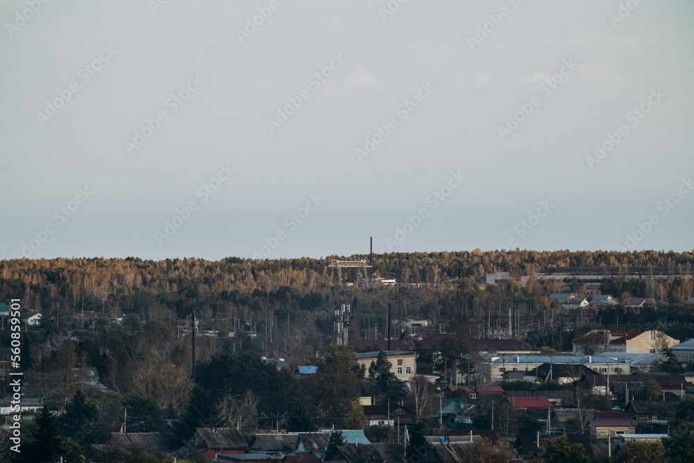 View of a small town, surrounded by forest and nature. City landscape.