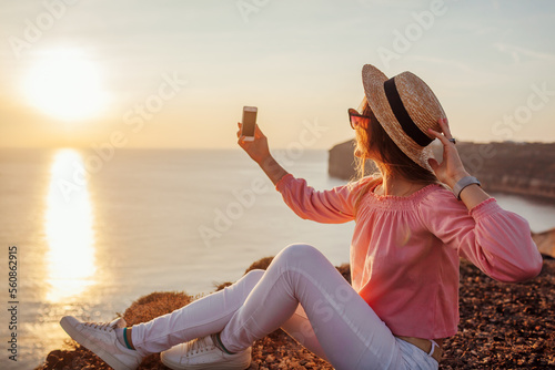 Photography Tourist taking selfie on phone on Aegean sea background on Santorini island, Greece