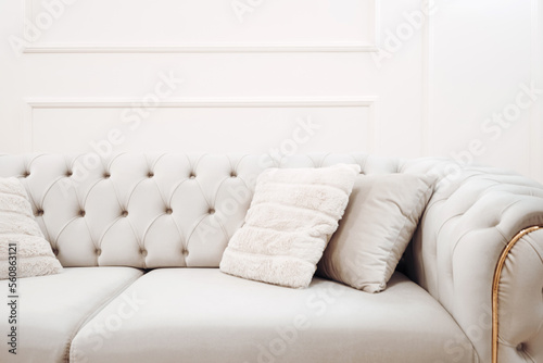 Stylish sofa, details of couch fabric and pillows. Boho design, comfortable sofa with textures and modern furniture