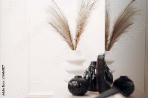 Close up of stylish vase with artificial plant