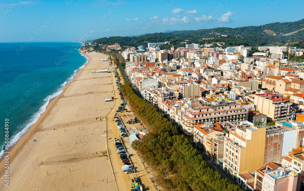 Birds eye view of Calella, Spain. Residential building along Mediterranean sea coast and beach visible from above.
