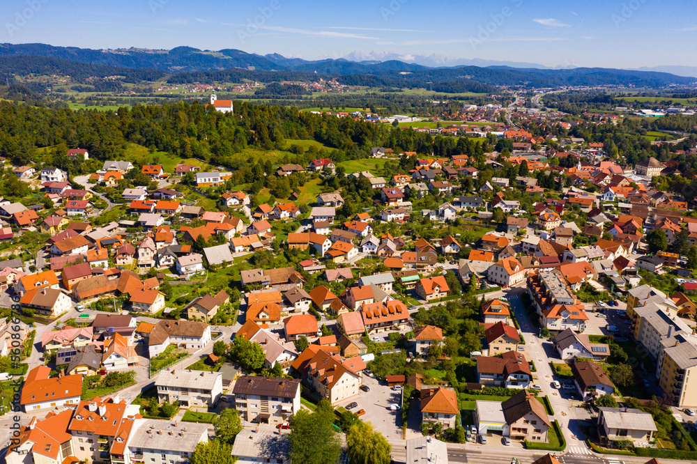 Picturesque autumn landscape of Ljubljana Marshes overlooking brownish roofs of houses of small Slovenian town of Vrhnika