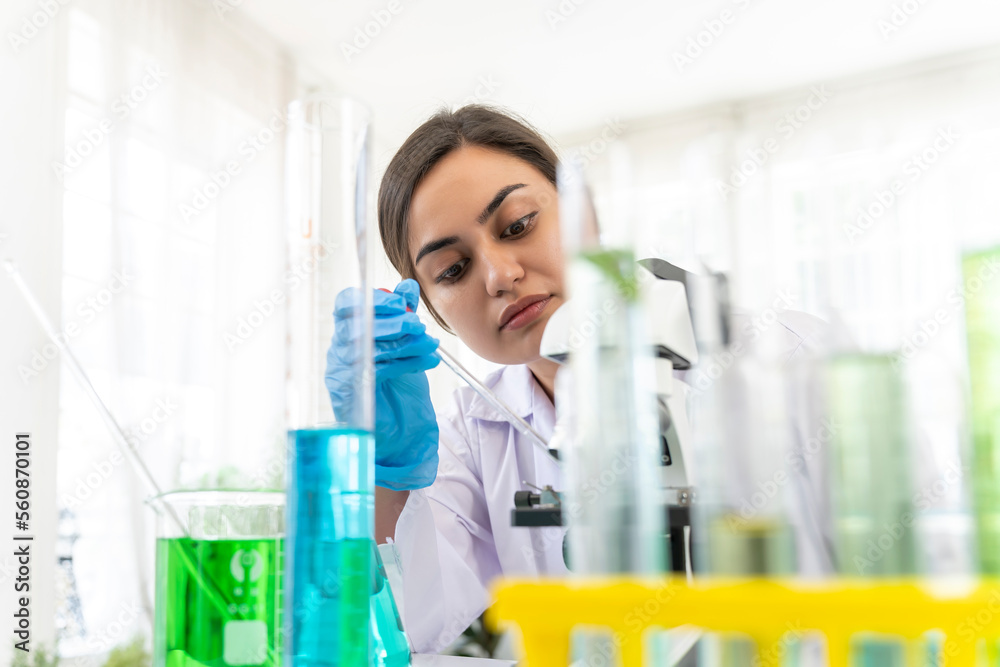 Young female scientist working with tube test in laboratory Young female scientist working with tube test in laboratory