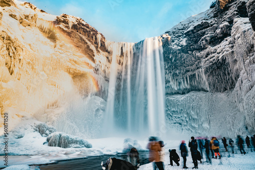 Billede på lærred Dreamy looking Skogafoss waterfall in winter with rainbow and people