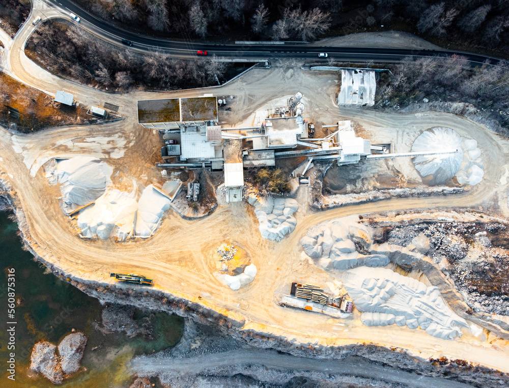 Stone quarry supporting and industrial buildings with stone crusher and gravel preparation. Aerial drone view