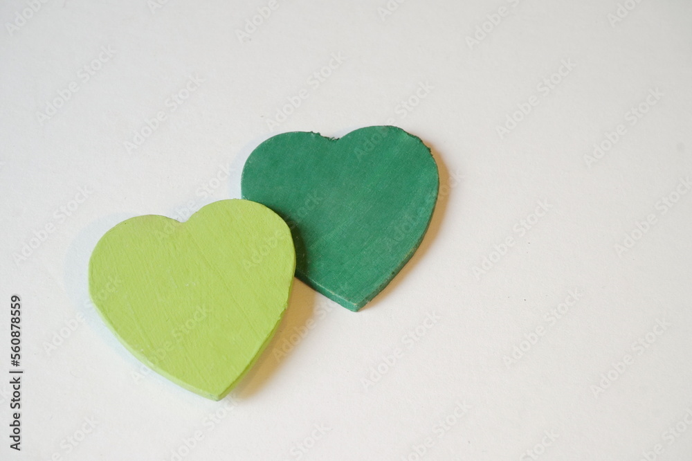 Obraz premium Dark Green and Overlapping Light Green Heart on White with Room for Text