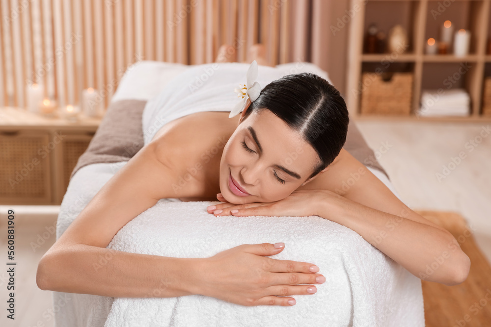 Young woman resting on massage couch in spa salon Young woman resting on massage couch in spa salon