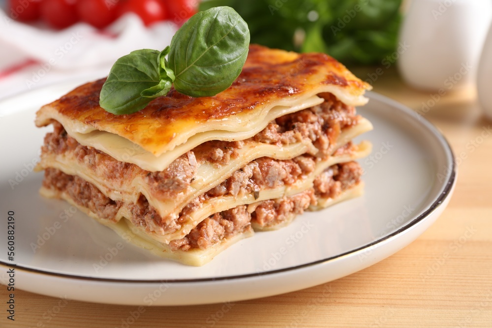 Delicious cooked lasagna served on wooden table