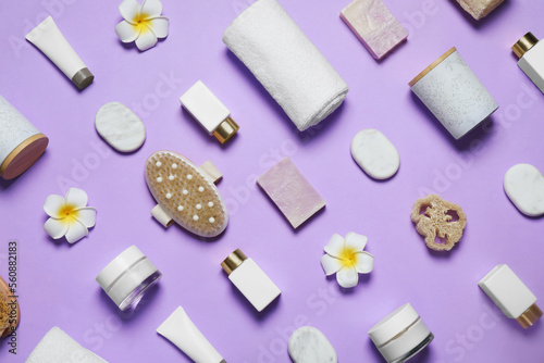 Spa essentials on violet background, flat lay