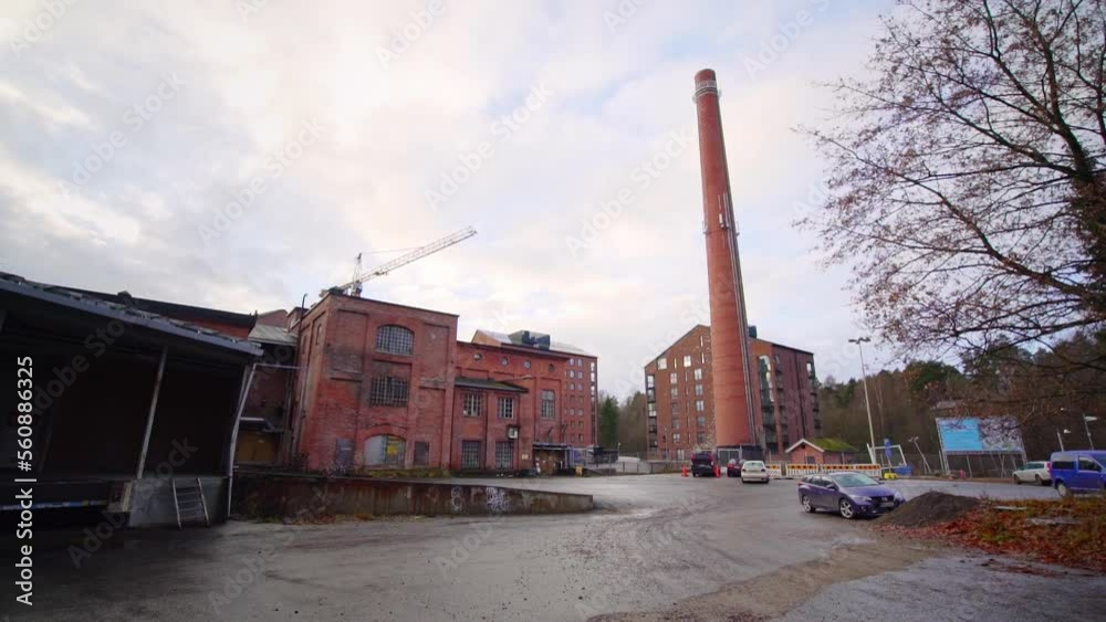 Modern apartment building and a chimney on the yard of an old factory district Modern apartment building and a chimney on the yard of an old factory district