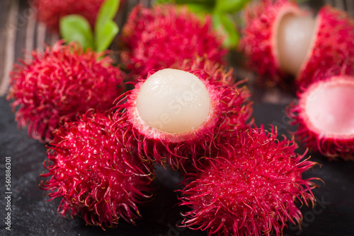 fresh ripe rambutan fruit on wooden table