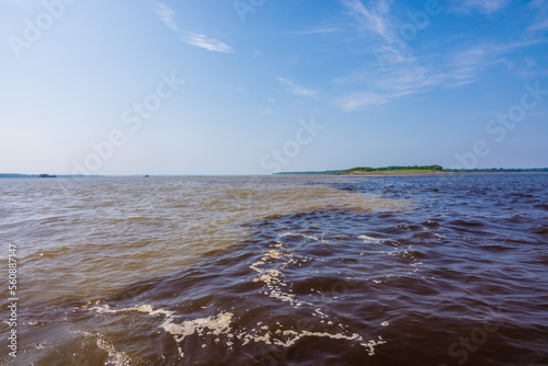 View of the The Meeting of Waters  the confluence between the dark Rio Negro and the pale Solimoes River - Amazonas  Brazil